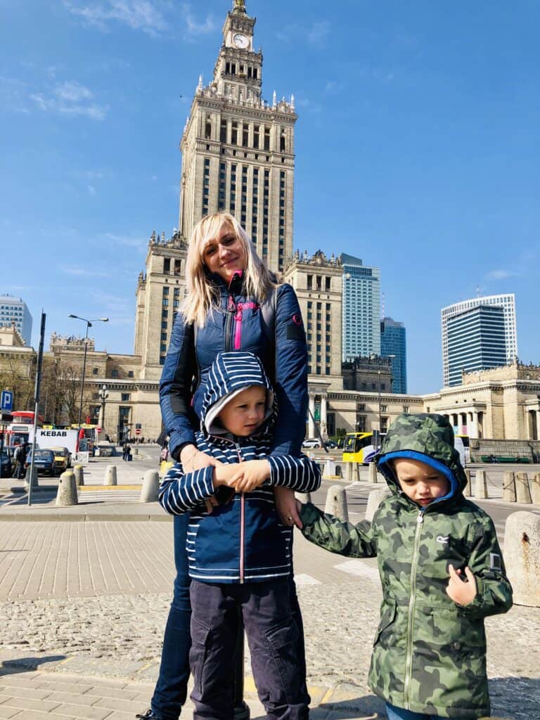 Picture of me and my 2 boys in front of the Palace of Culture and Science